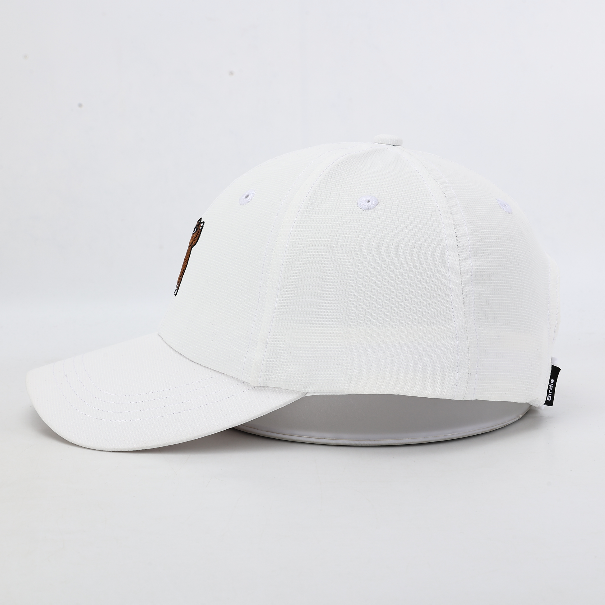 White performance hat with Brown Bear, Side