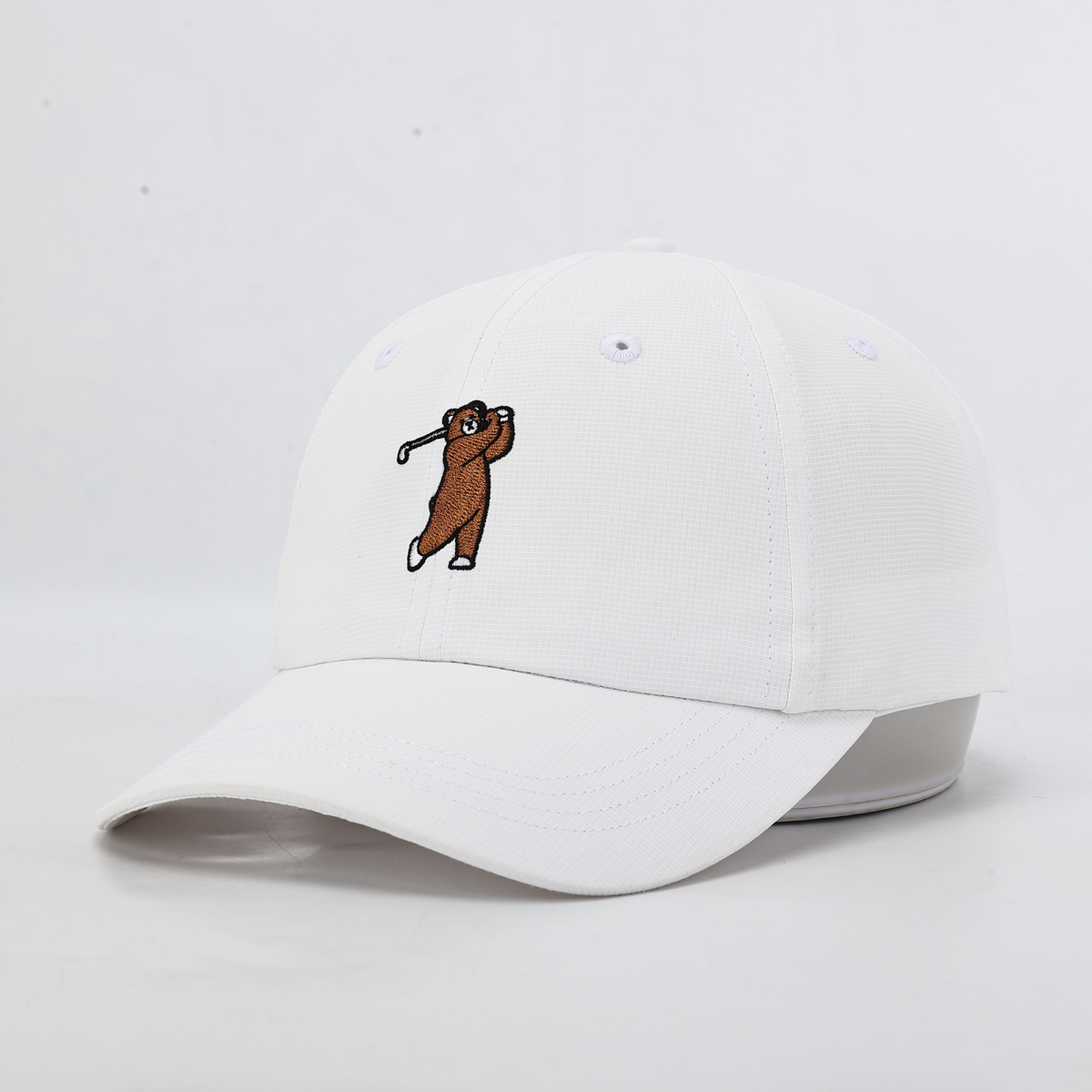 White performance hat with Brown Bear, Angled