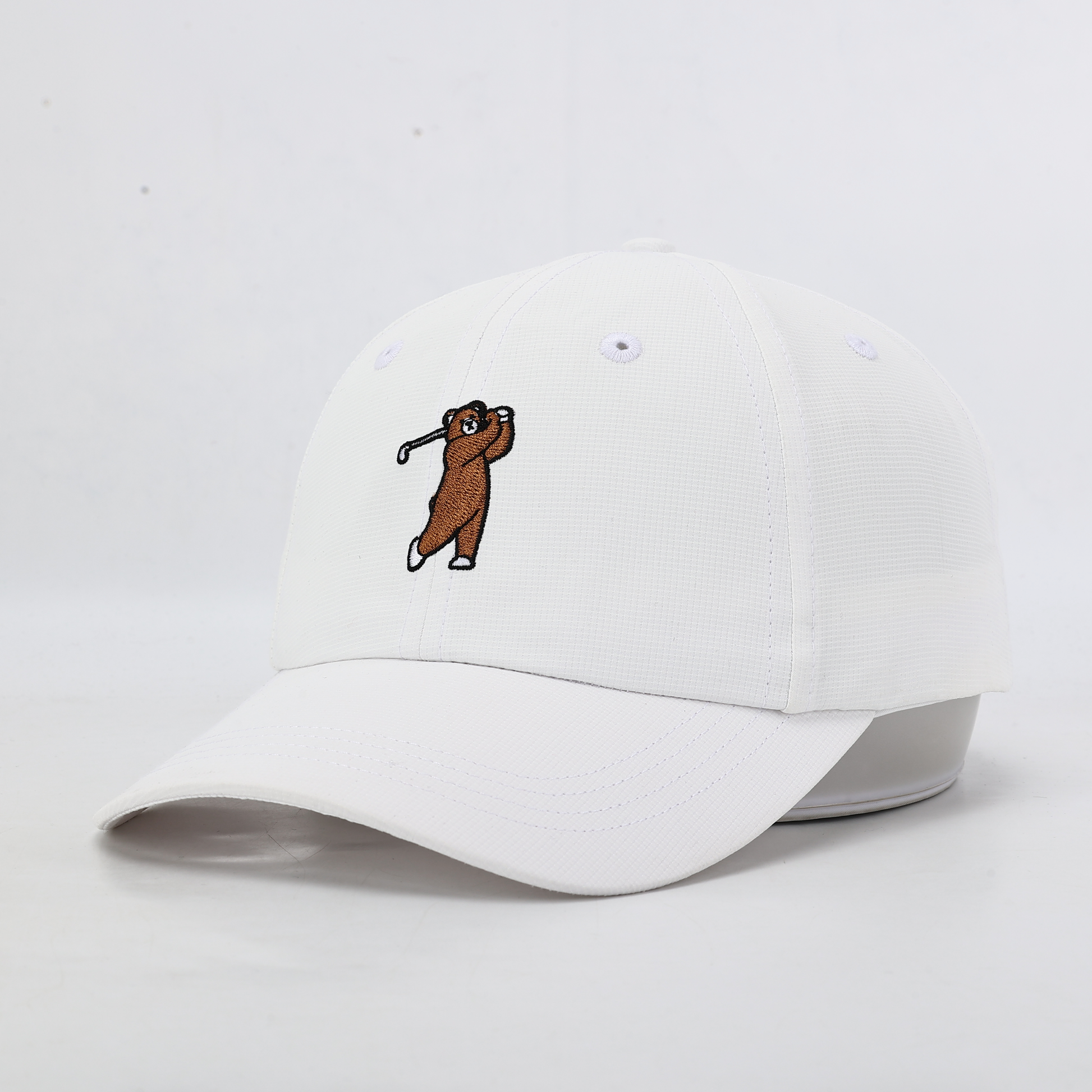 White performance hat with Brown Bear, Angled