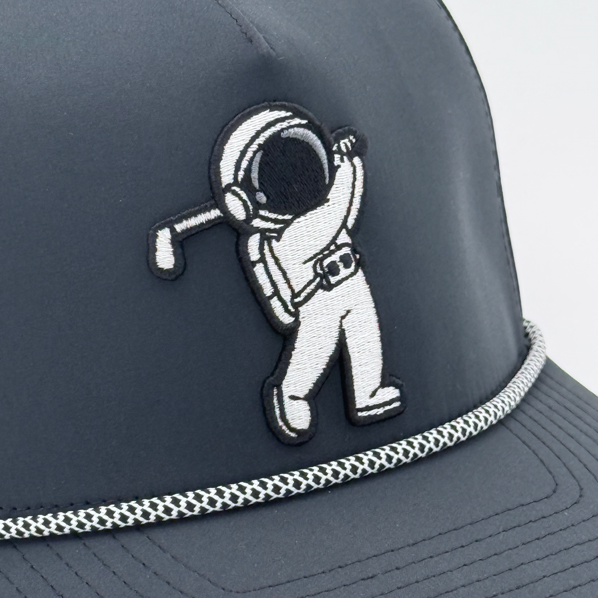 Black Rope Hat with astronaut golfer embroidered patch, close up