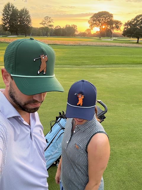 Couple on golf course, brown bear rope and lion rope hats